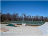 Tennis and basketball court beside skate park