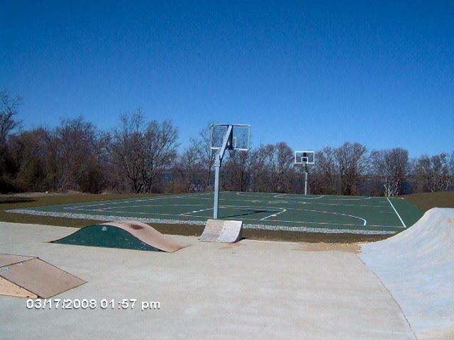 Tennis and basketball court beside skate park